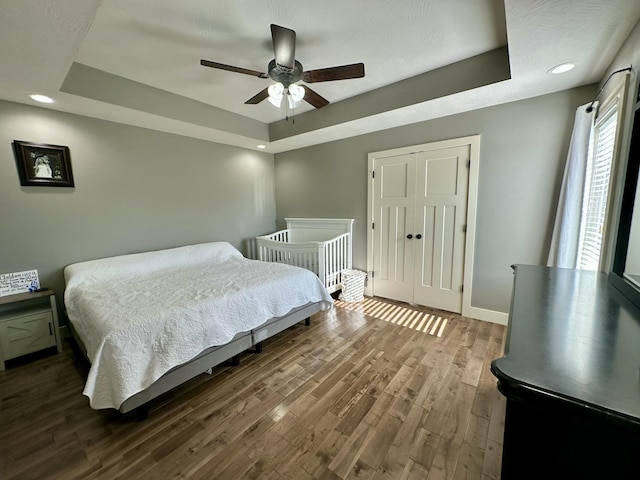 923 Riverview Rd, Marshfield, MO 65706 - bedroom with a raised ceiling, dark wood-style flooring, recessed lighting, baseboards, and a ceiling fan