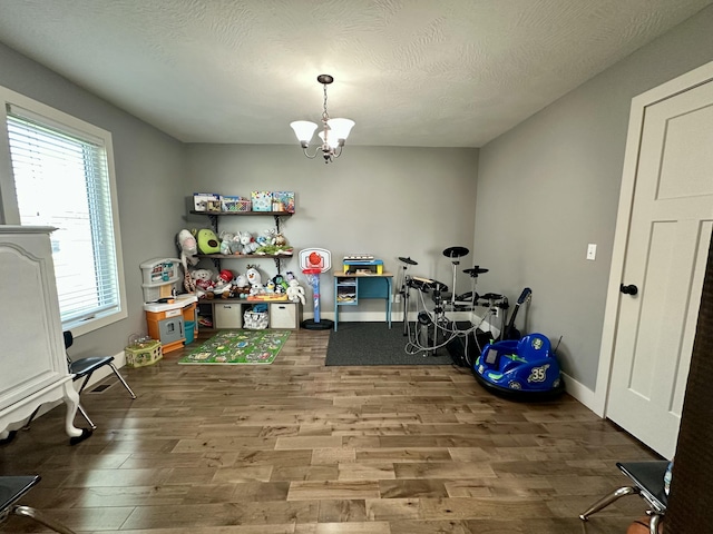923 Riverview Rd, Marshfield, MO 65706 - playroom with wood finished floors, a chandelier, and baseboards