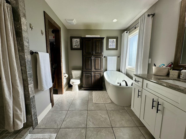 923 Riverview Rd, Marshfield, MO 65706 - bathroom with vanity, a soaking tub, toilet, tile patterned flooring, and baseboards