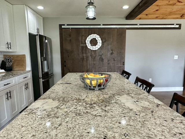 923 Riverview Rd, Marshfield, MO 65706 - kitchen featuring stainless steel refrigerator with ice dispenser, white cabinets, light stone counters, recessed lighting, and pendant lighting