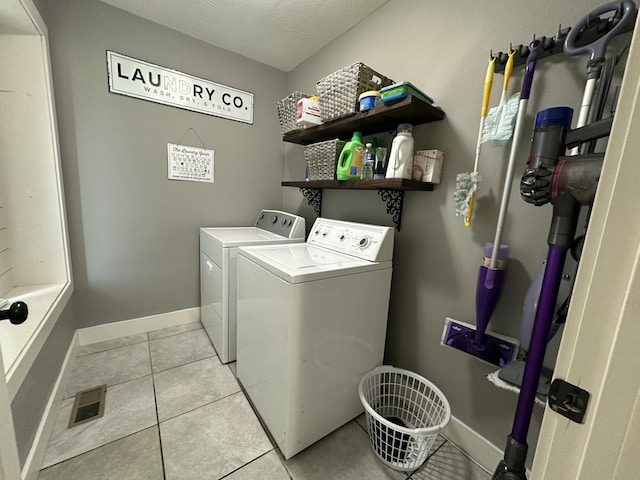 923 Riverview Rd, Marshfield, MO 65706 - laundry room with washer and clothes dryer, light tile patterned flooring, and baseboards