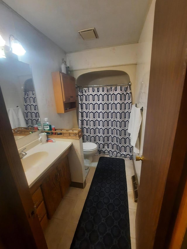 2504 N Clayton Ave, Springfield, MO 65803 - full bath with toilet, vanity, a shower with shower curtain, and tile patterned flooring