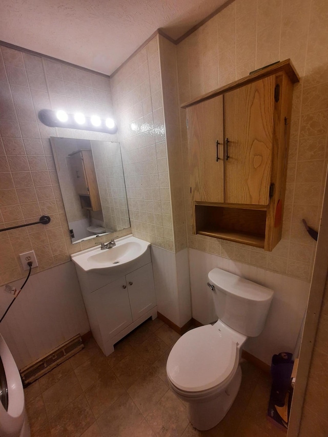 2504 N Clayton Ave, Springfield, MO 65803 - bathroom with tile walls, vanity, and toilet