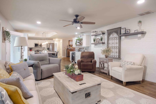 248 Charles Rd, Billings, MO 65610 - living room featuring light wood-style flooring, a ceiling fan, recessed lighting, a chandelier, and brick wall