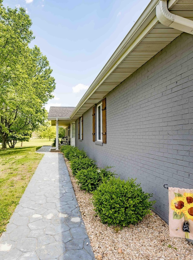248 Charles Rd, Billings, MO 65610 - view of side of home featuring brick siding and a lawn