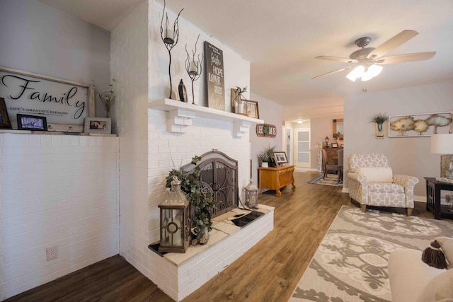 248 Charles Rd, Billings, MO 65610 - living area with wood finished floors, a fireplace, and a ceiling fan