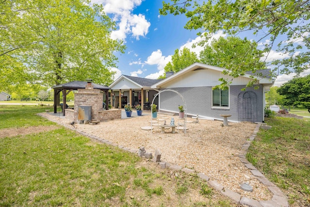 248 Charles Rd, Billings, MO 65610 - back of house featuring a gazebo, a lawn, brick siding, and a chimney