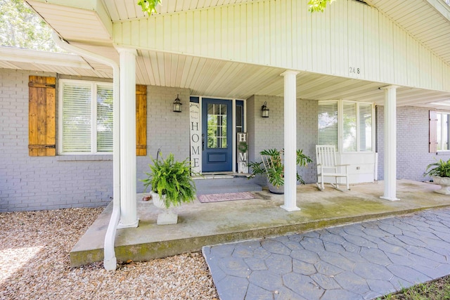 248 Charles Rd, Billings, MO 65610 - view of exterior entry featuring covered porch and brick siding