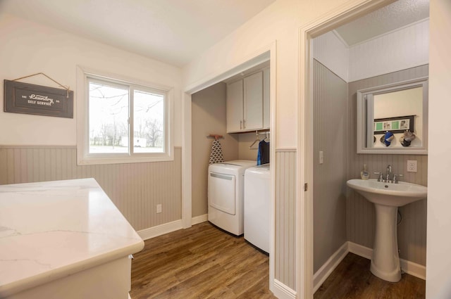 248 Charles Rd, Billings, MO 65610 - laundry area featuring independent washer and dryer, wainscoting, wood finished floors, and cabinet space