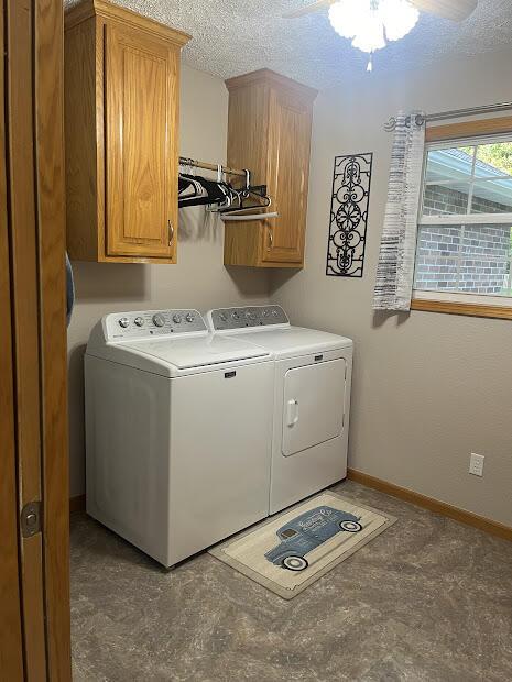 4120 S 119th Rd, Bolivar, MO 65613 - laundry area with washer and dryer, cabinet space, a textured ceiling, baseboards, and ceiling fan