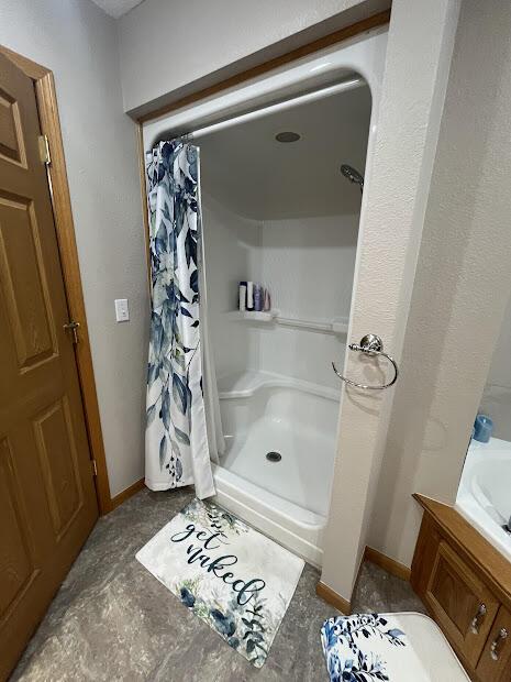 4120 S 119th Rd, Bolivar, MO 65613 - bathroom featuring curtained shower, vanity, and baseboards
