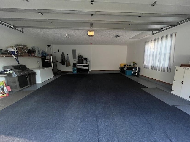 4120 S 119th Rd, Bolivar, MO 65613 - garage featuring electric panel, freestanding refrigerator, and a garage door opener