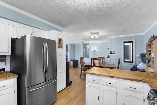 25451 County Road 327, Urbana, MO 65767 - kitchen with freestanding refrigerator, wooden counters, crown molding, white cabinetry, and light wood-type flooring