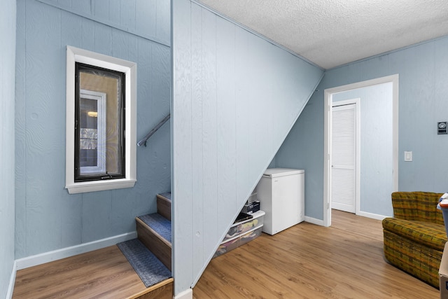 25451 County Road 327, Urbana, MO 65767 - staircase with wood finished floors, baseboards, and a textured ceiling