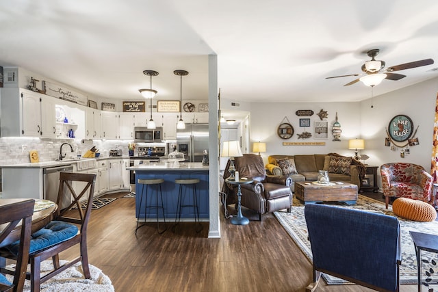 150 Sunken Forest Dr Unit 106, Forsyth, MO 65653 - living room featuring ceiling fan and dark wood-style flooring