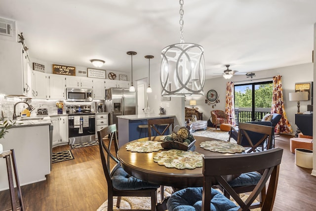 150 Sunken Forest Dr Unit 106, Forsyth, MO 65653 - dining room featuring a ceiling fan and dark wood-style flooring
