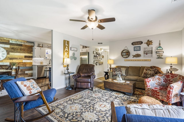 150 Sunken Forest Dr Unit 106, Forsyth, MO 65653 - living room featuring a ceiling fan, dark wood-type flooring, and baseboards