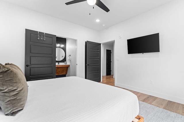 400 Poolside Pass, Hollister, MO 65672 - bedroom featuring wood finished floors, ceiling fan, and ensuite bathroom
