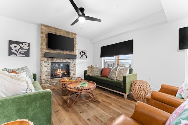 400 Poolside Pass, Hollister, MO 65672 - living area featuring wood finished floors, a stone fireplace, and a ceiling fan