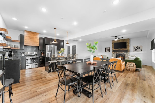 400 Poolside Pass, Hollister, MO 65672 - dining room with a ceiling fan, recessed lighting, light wood finished floors, and a fireplace