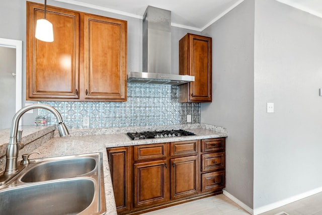 318 W Olive St, Aurora, MO 65605 - kitchen with a sink, wall chimney exhaust hood, stainless steel gas stovetop, brown cabinetry, and decorative backsplash