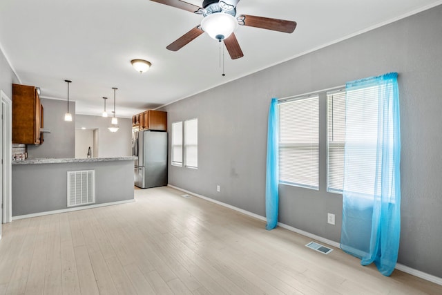 318 W Olive St, Aurora, MO 65605 - unfurnished living room with a ceiling fan, baseboards, and light wood-type flooring