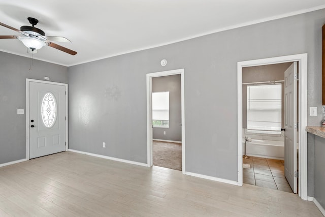 318 W Olive St, Aurora, MO 65605 - entrance foyer featuring ceiling fan, baseboards, light wood-type flooring, and ornamental molding