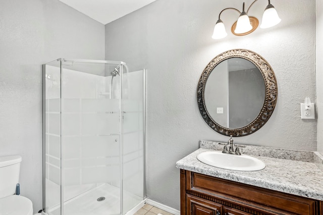 318 W Olive St, Aurora, MO 65605 - bathroom with toilet, vanity, a stall shower, and tile patterned floors