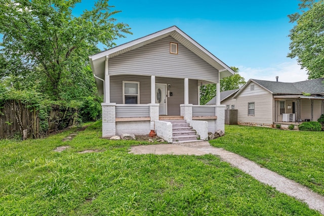 318 W Olive St, Aurora, MO 65605 - shotgun-style home featuring a porch