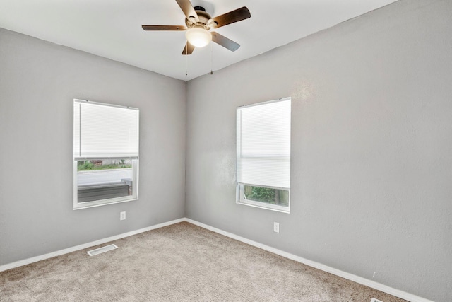 318 W Olive St, Aurora, MO 65605 - carpeted empty room with healthy amount of natural light, a ceiling fan, and baseboards