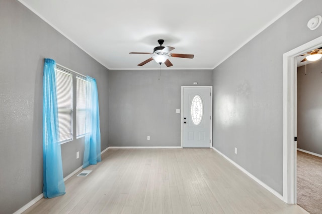 318 W Olive St, Aurora, MO 65605 - entryway with ceiling fan, healthy amount of natural light, wood finished floors, ornamental molding, and baseboards
