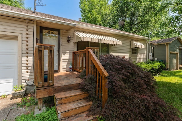 2140 N Crutcher Ave, Springfield, MO 65803 - property entrance featuring a shingled roof and a garage