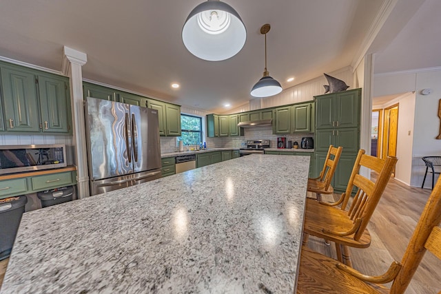 25832 County Road 250, Hermitage, MO 65668 - kitchen with green cabinets, appliances with stainless steel finishes, ornamental molding, backsplash, and light stone counters