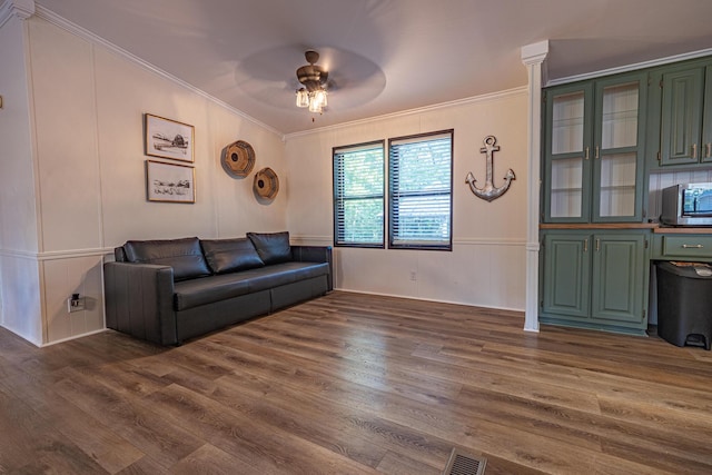 25832 County Road 250, Hermitage, MO 65668 - living area featuring crown molding, dark wood-type flooring, a ceiling fan, and a decorative wall