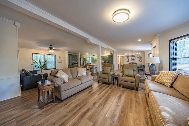 25832 County Road 250, Hermitage, MO 65668 - living room featuring a chandelier, crown molding, light wood-style flooring, plenty of natural light, and ceiling fan