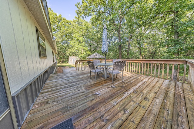 25832 County Road 250, Hermitage, MO 65668 - wooden deck with outdoor dining area and view of scattered trees