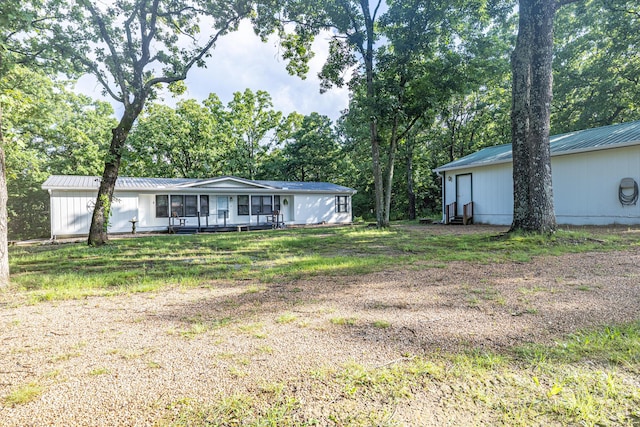 25832 County Road 250, Hermitage, MO 65668 - view of front facade featuring metal roof and view of wooded area