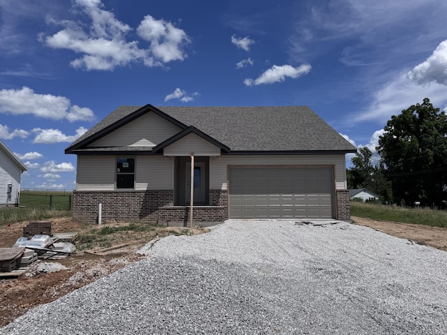 356 N Oak Ave, Sparta, MO 65753 - view of front of property featuring brick siding, driveway, and a garage