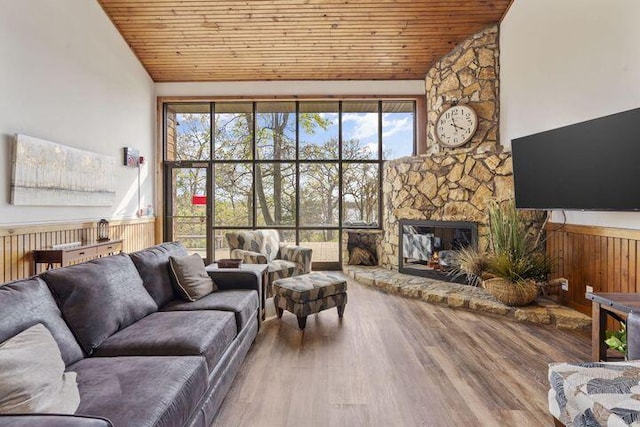 234 Sunset Cv Unit 107, Branson, MO 65616 - living room featuring wooden ceiling, wood finished floors, a stone fireplace, and high vaulted ceiling