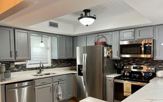 234 Sunset Cv Unit 107, Branson, MO 65616 - kitchen with stainless steel appliances, gray cabinets, a sink, and a raised ceiling