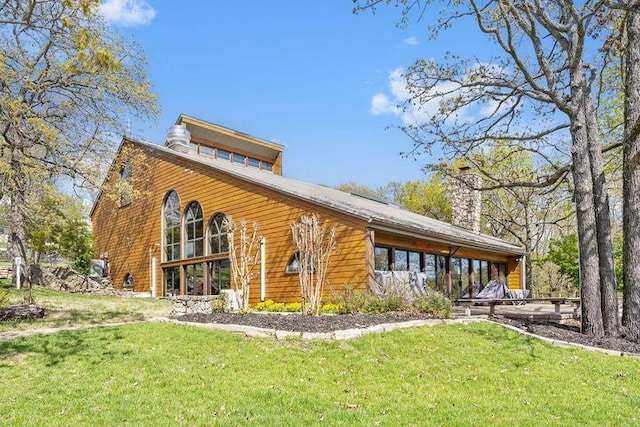234 Sunset Cv Unit 107, Branson, MO 65616 - back of house featuring a yard and a chimney