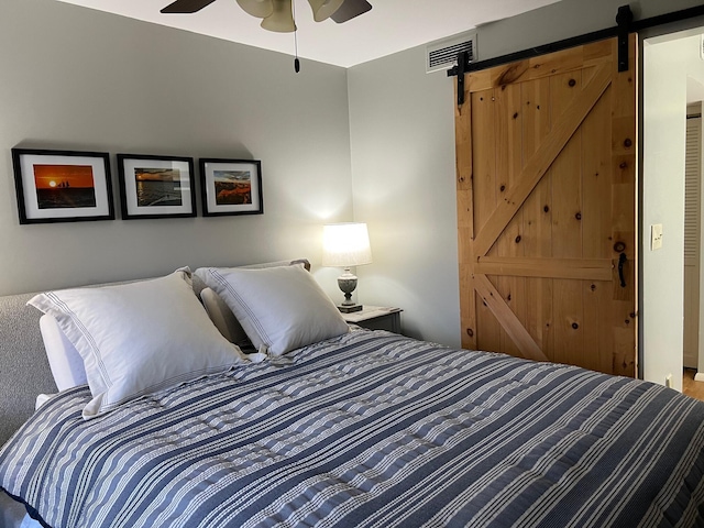 234 Sunset Cv Unit 107, Branson, MO 65616 - bedroom featuring a barn door and ceiling fan