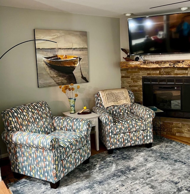 234 Sunset Cv Unit 107, Branson, MO 65616 - living area with wood finished floors and a stone fireplace