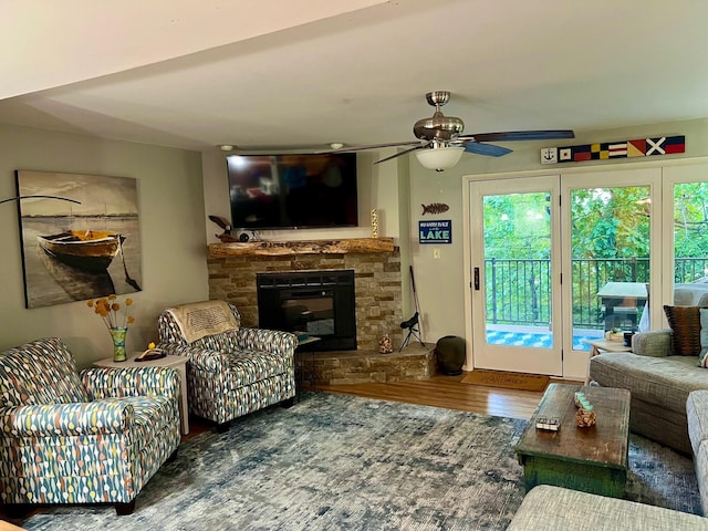 234 Sunset Cv Unit 107, Branson, MO 65616 - living area featuring wood finished floors, a ceiling fan, and a fireplace