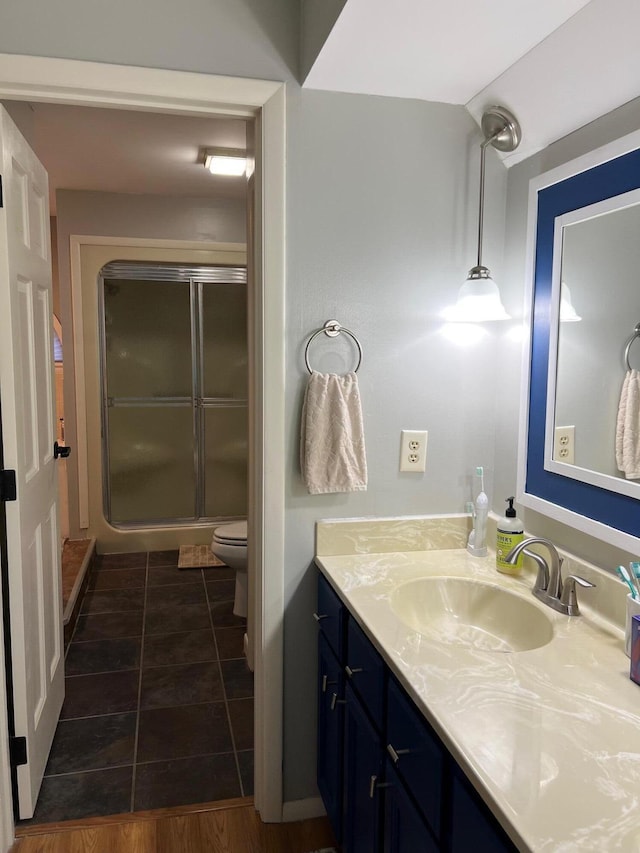 234 Sunset Cv Unit 107, Branson, MO 65616 - full bathroom featuring vanity, toilet, a stall shower, and tile patterned flooring