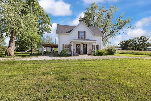 214 Rudolph St, Seymour, MO 65746 - view of front facade featuring a carport, a front yard, covered porch, a shingled roof, and gravel driveway