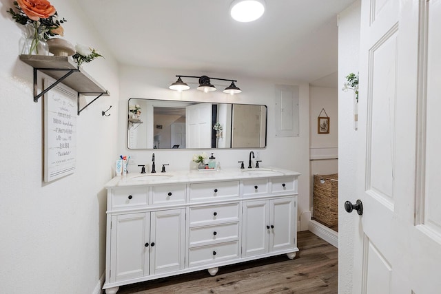 214 Rudolph St, Seymour, MO 65746 - bathroom featuring double vanity, baseboards, electric panel, and wood finished floors