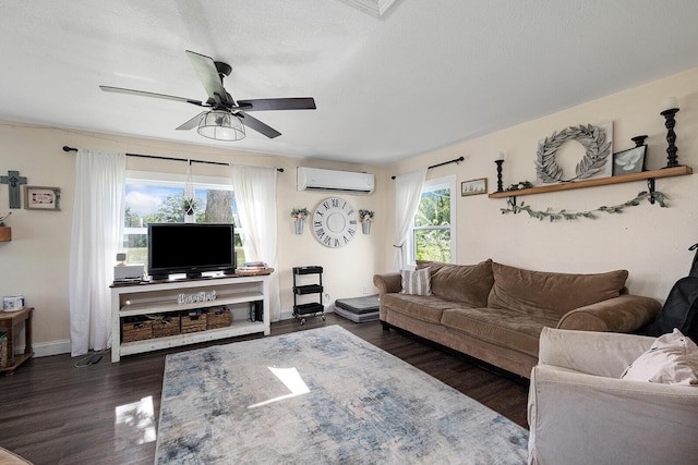 214 Rudolph St, Seymour, MO 65746 - living area featuring a wall mounted air conditioner, dark wood-style flooring, ceiling fan, and baseboards