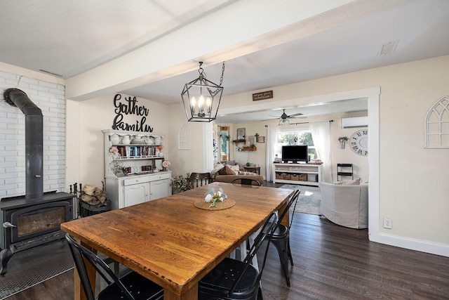 214 Rudolph St, Seymour, MO 65746 - dining area featuring a wood stove, dark wood finished floors, a ceiling fan, an AC wall unit, and baseboards