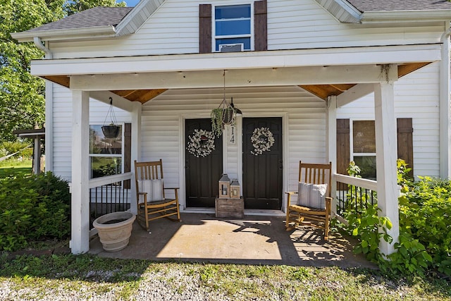 214 Rudolph St, Seymour, MO 65746 - view of exterior entry featuring roof with shingles and a porch